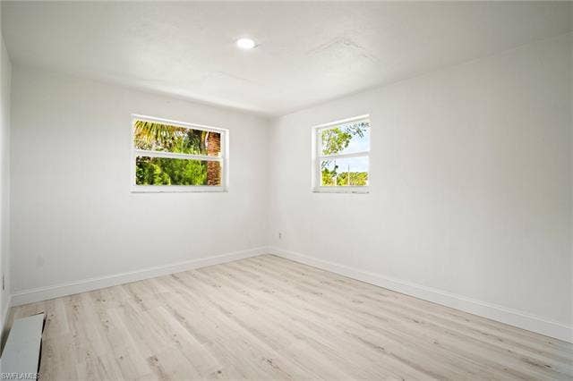 2316 Bayside St, Naples, FL 34112 Empty room with light wood-style flooring and recessed lighting