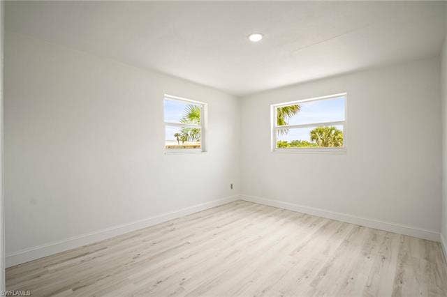 2316 Bayside St, Naples, FL 34112 Empty room with light wood-style floors and recessed lighting