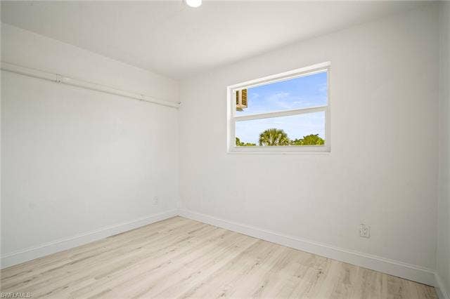 2316 Bayside St, Naples, FL 34112 Spare room featuring wood finished floors and recessed lighting