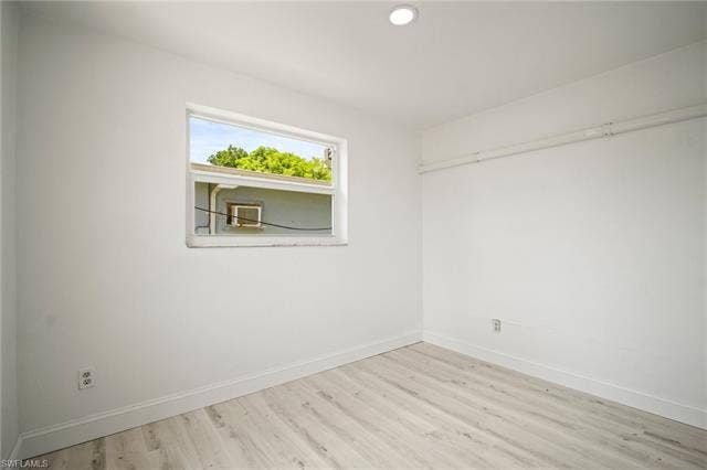 2316 Bayside St, Naples, FL 34112 Empty room with wood finished floors and recessed lighting