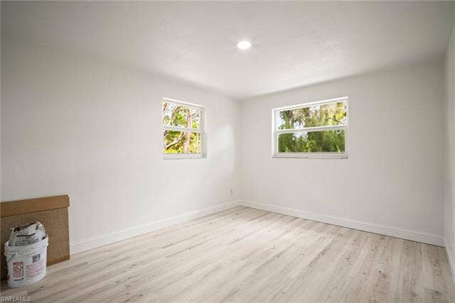 2316 Bayside St, Naples, FL 34112 Empty room with light wood-style floors and recessed lighting