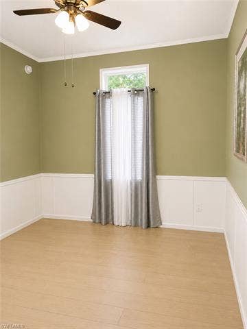 20472 Luettich Ln, Estero, FL 33928 Room featuring wood-finish flooring, wainscoting, and a ceiling fan with integrated lighting