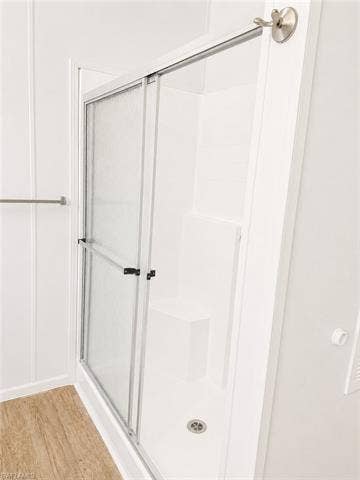 20472 Luettich Ln, Estero, FL 33928 White walk-in shower with sliding frosted glass door