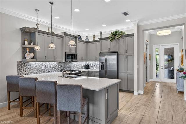 16459 Orinda Way, Bonita Springs, FL 34135 Bar seats 4! Custom woodwork on peninsula. Undercabinet lighting! Beautiful backsplash! Pantry!