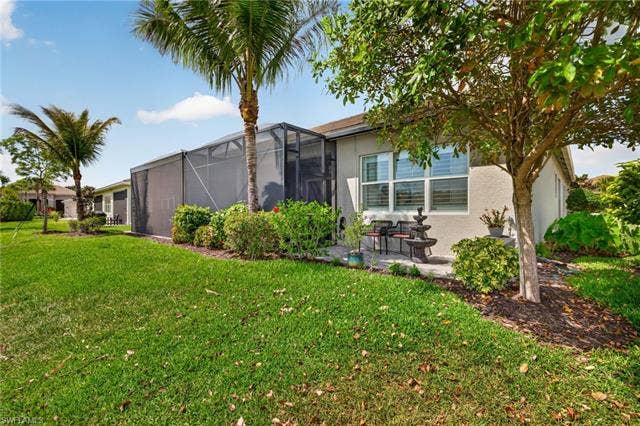 16459 Orinda Way, Bonita Springs, FL 34135 Great pix of the extended, caged, lanai PLUS the addition rear patio space outside the primary bedroom. All areas feature a lake view!