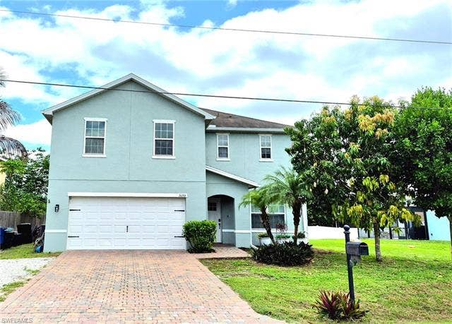 26701 Lincoln Ave, Bonita Springs, FL 34135 Two-story stucco residence with a two-car garage