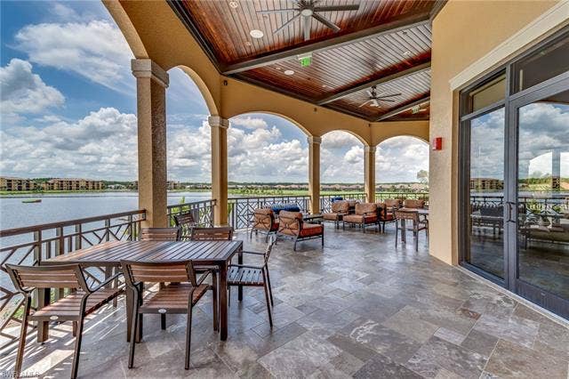 17921 Bonita National Blvd, #244, Bonita Springs, FL 34135 Expansive covered balcony featuring arched openings and a detailed wood-panel ceiling