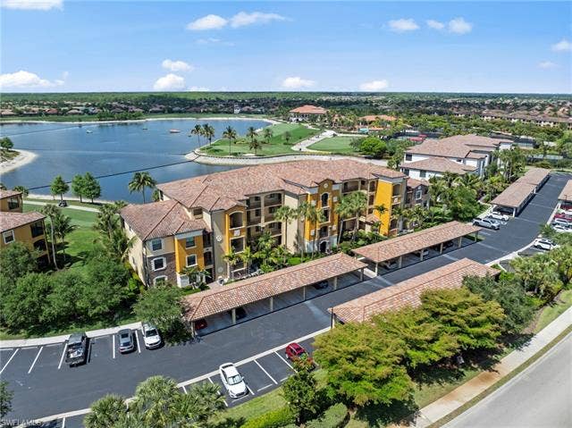 17921 Bonita National Blvd, #244, Bonita Springs, FL 34135 Multi-story residential building with stucco exterior and tile roofing, featuring multiple balconies