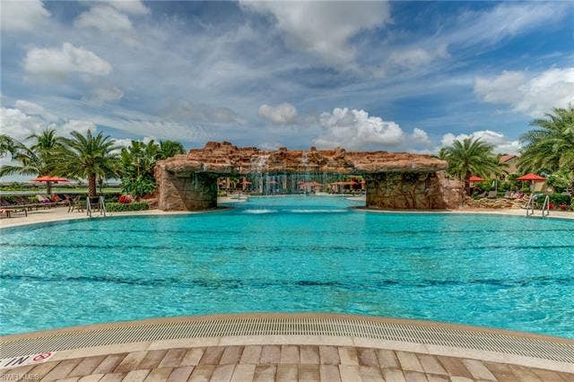 17921 Bonita National Blvd, #244, Bonita Springs, FL 34135 Expansive swimming pool featuring a rock-grotto waterfall structure