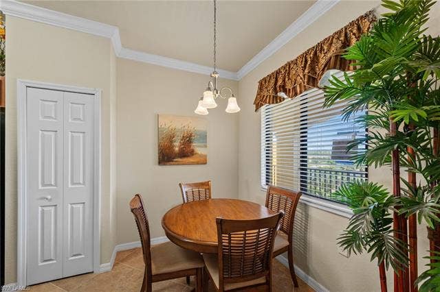 17921 Bonita National Blvd, #244, Bonita Springs, FL 34135 Dining area featuring crown molding, a window with horizontal blinds, and a multi-light pendant fixture