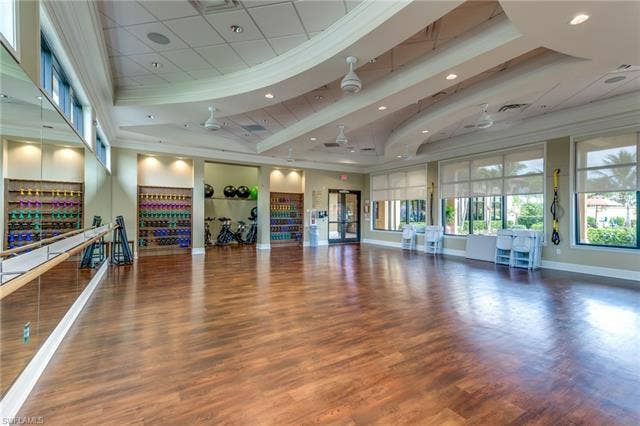 17921 Bonita National Blvd, #244, Bonita Springs, FL 34135 Spacious multi-purpose room featuring wood-finish flooring, mirrored wall with ballet barre, recessed lighting, and large windows with roller shades