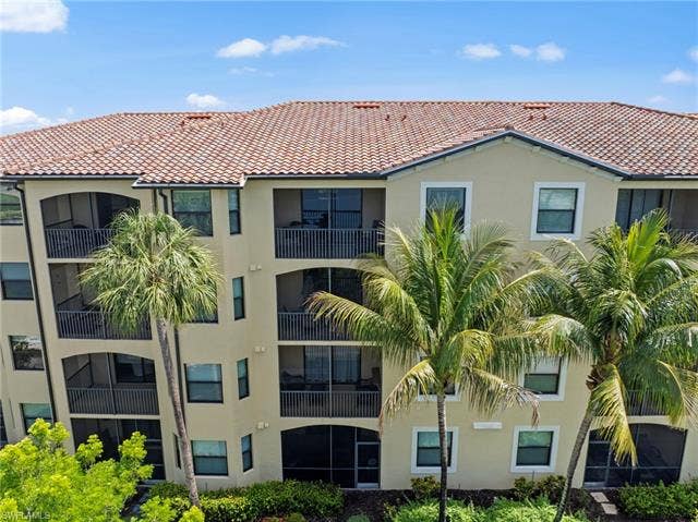 17921 Bonita National Blvd, #244, Bonita Springs, FL 34135 Multi-story residential building featuring a tile roof and stucco exterior