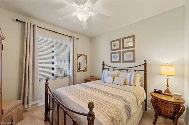 17921 Bonita National Blvd, #244, Bonita Springs, FL 34135 Bedroom featuring a ceiling fan with integrated lighting, a window with horizontal blinds and drapes, and neutral wall tones