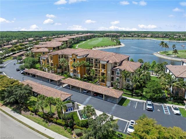 17921 Bonita National Blvd, #244, Bonita Springs, FL 34135 Multi-story residential buildings featuring tiled roofs and covered parking structures
