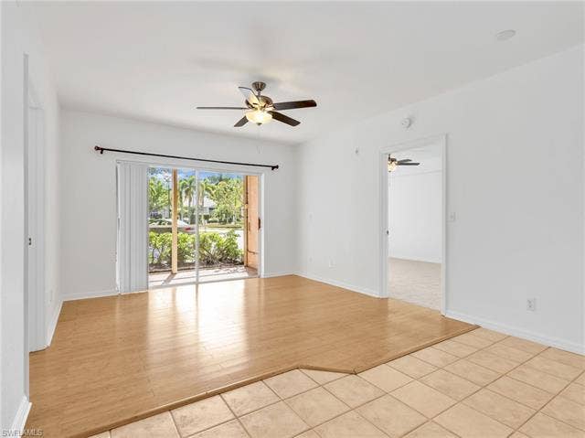 27087 Matheson Ave, #101, Bonita Springs, FL 34135 Living Room & Dining Area with Ceiling Fan and Sliders Leading to Screened In Lanai With Electric Hurricane Shutter