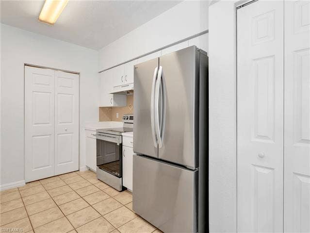 27087 Matheson Ave, #101, Bonita Springs, FL 34135 Kitchen with Tile Flooring, White Cabinetry, Stainless Steel Appliances Including new LG French Door Refrigerator & Range, Tile Backsplash & Pantry