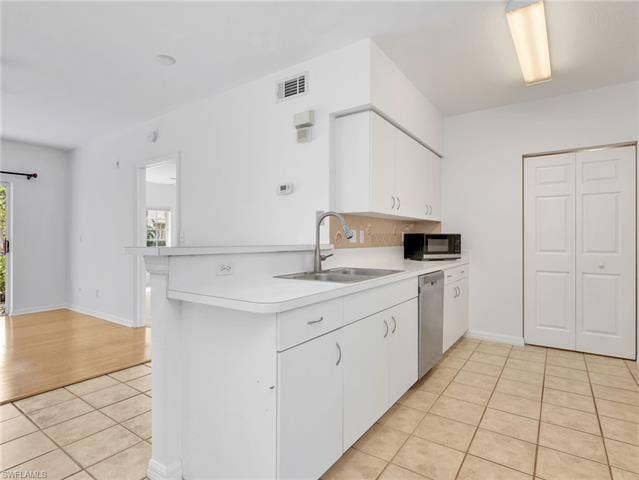 27087 Matheson Ave, #101, Bonita Springs, FL 34135 Kitchen with Tile Flooring, White Cabinetry, Stainless Steel Appliances Including new LG French Door Refrigerator & Range, Newer Whirlpool Dishwasher, Tile Backsplash & Pantry