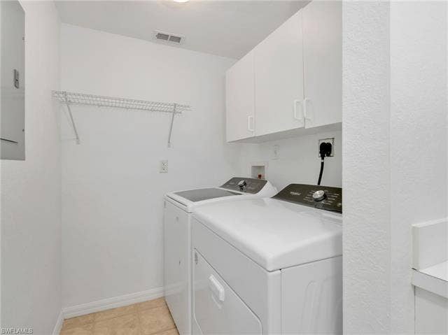 27087 Matheson Ave, #101, Bonita Springs, FL 34135 Laundry Room with Whirlpool Washer & Dryer (2025), Wire Hanging Rack, & White Cabinetry