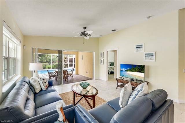 28179 Islet Trl, Bonita Springs, FL 34135 Open-concept living space featuring light-toned tile flooring and vaulted ceilings
