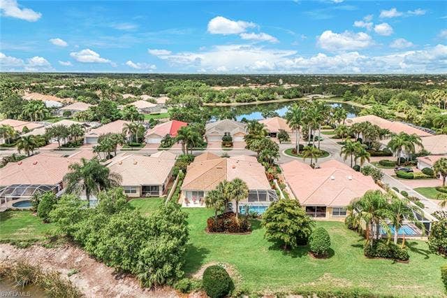 28179 Islet Trl, Bonita Springs, FL 34135 Aerial perspective showcasing a residential community with abundant mature trees and lush green landscaping