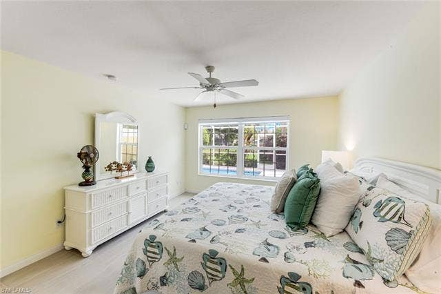 28179 Islet Trl, Bonita Springs, FL 34135 Spacious bedroom featuring light-toned walls, a ceiling fan, and light wood-finish flooring