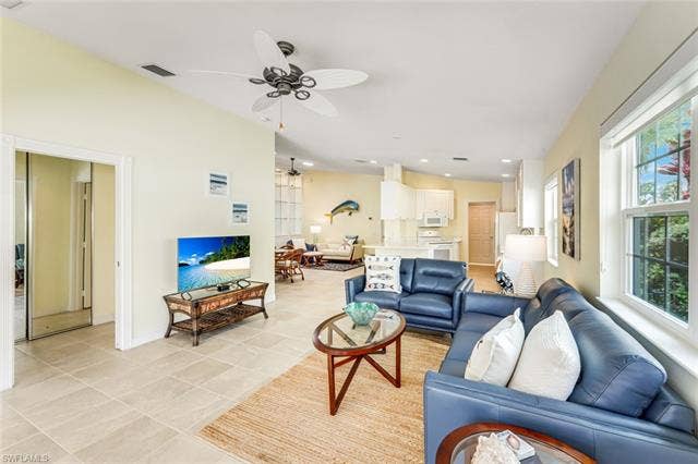 28179 Islet Trl, Bonita Springs, FL 34135 Open-concept living area featuring tile flooring, high ceilings, and a ceiling fan