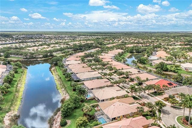 28179 Islet Trl, Bonita Springs, FL 34135 Aerial view showcasing a residential community with numerous properties featuring tile roofs