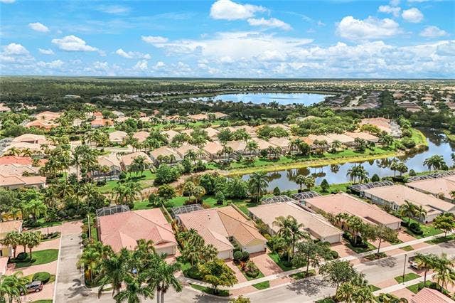 28179 Islet Trl, Bonita Springs, FL 34135 Expansive aerial perspective showcasing a residential community with water features and lush landscaping