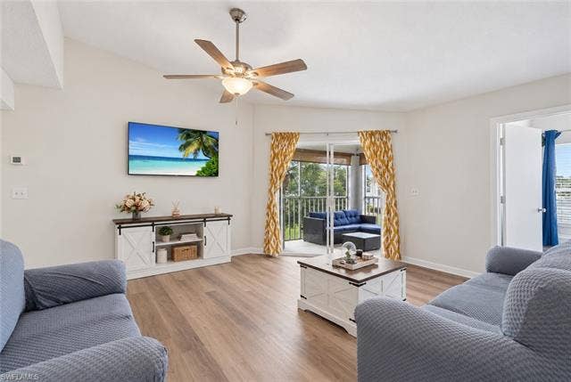 132 Santa Clara Dr, #10, Naples, FL 34104 Wood-finish flooring throughout, vaulted ceiling, and sliding glass doors opening to a screened balcony
