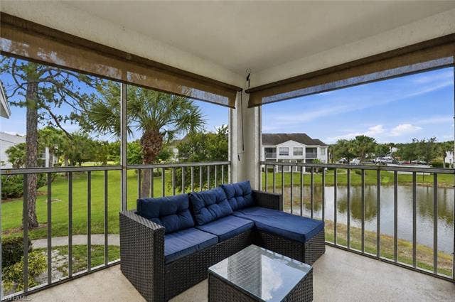 132 Santa Clara Dr, #10, Naples, FL 34104 Screened balcony featuring a concrete floor and roller shades