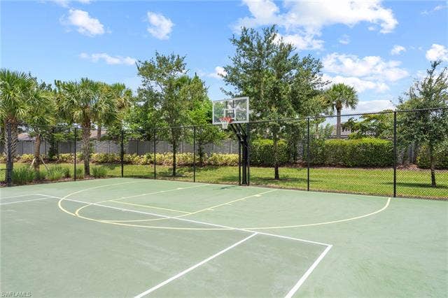 16112 Bonita Landing Cir, Bonita Springs, FL 34135 Outdoor basketball court featuring a clear backboard and a black chain-link fence perimeter