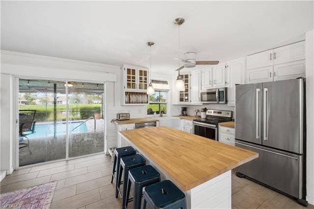 24708 Carnoustie Ct, Bonita Springs, FL 34135 An amazing view of the pool and the lake from the kitchen