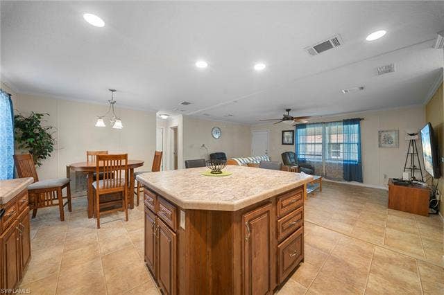 27472 Rue Viauv Ave, Bonita Springs, FL 34135 Kitchen island with tile-finish countertop and wood cabinetry