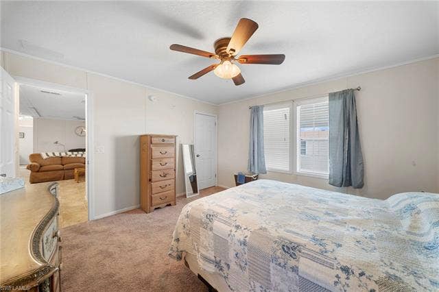 27472 Rue Viauv Ave, Bonita Springs, FL 34135 Carpeted bedroom featuring a ceiling fan with light fixture, white trim, and two windows with blinds