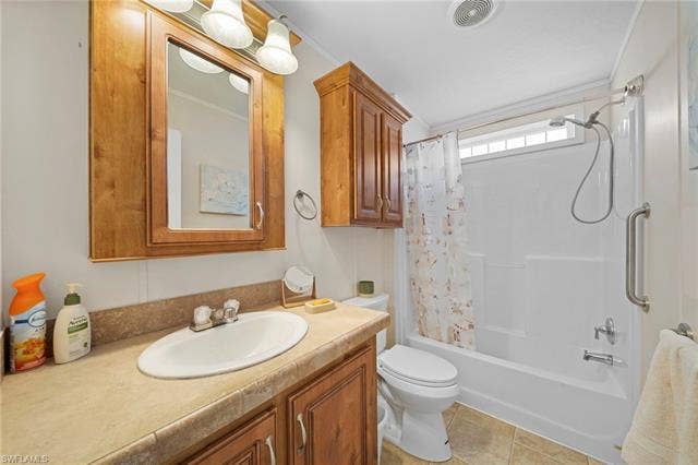27472 Rue Viauv Ave, Bonita Springs, FL 34135 Bathroom featuring a light wood-finish vanity with a single basin, a matching mirrored medicine cabinet, and overhead sconce lighting