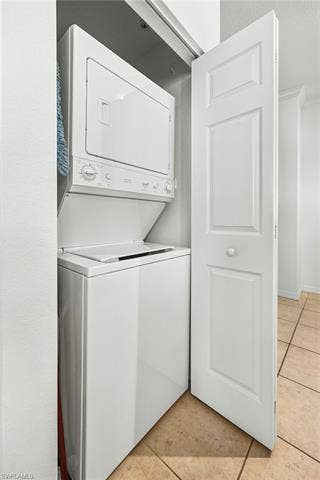 23461 Alamanda Dr, #206, Estero, FL 34135 Dedicated laundry closet featuring a white stacked washer and dryer unit