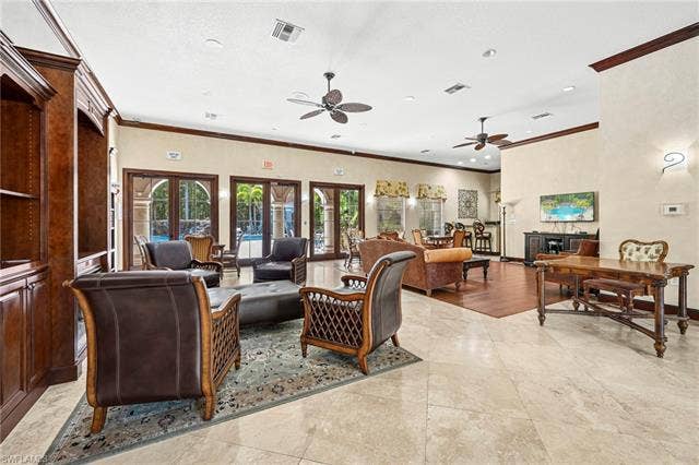 23461 Alamanda Dr, #206, Estero, FL 34135 Spacious common area featuring light-toned tile flooring, recessed lighting, and multiple ceiling fans