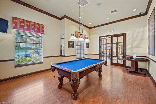 23461 Alamanda Dr, #206, Estero, FL 34135 Recreation room featuring wood-finish flooring, a pool table with blue felt, and dual French doors