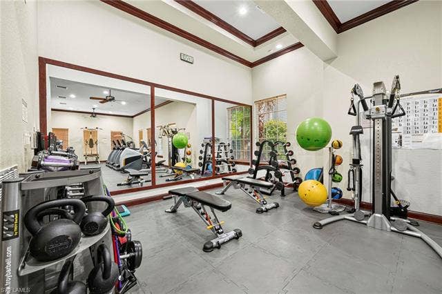 23461 Alamanda Dr, #206, Estero, FL 34135 Dedicated fitness room featuring interlocking rubber floor tiles, a mirrored wall, and recessed ceiling lighting