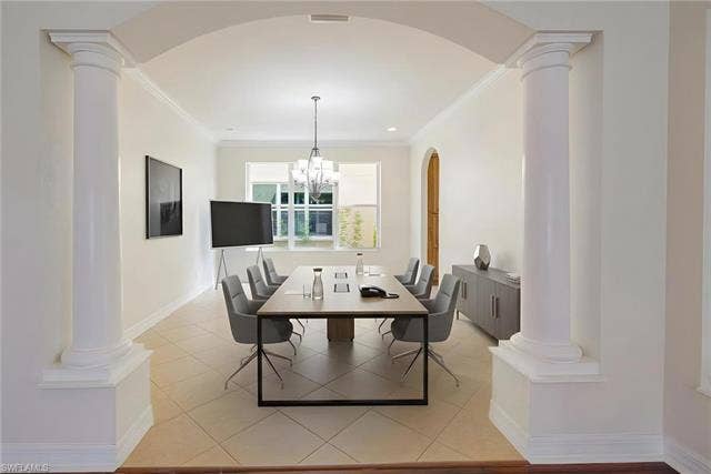 10310 Carolina Willow Dr, Fort Myers, FL 33913 Arched entryway with classical columns, recessed lighting, and a chandelier