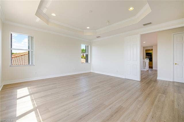 10310 Carolina Willow Dr, Fort Myers, FL 33913 Recessed lighting, crown molding, tray ceiling, wood-finish flooring, and white interior doors