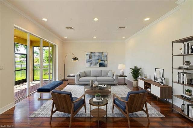 10310 Carolina Willow Dr, Fort Myers, FL 33913 Sophisticated living room showcasing hardwood flooring, recessed ceiling lighting, and glass sliding doors opening to outdoor space
