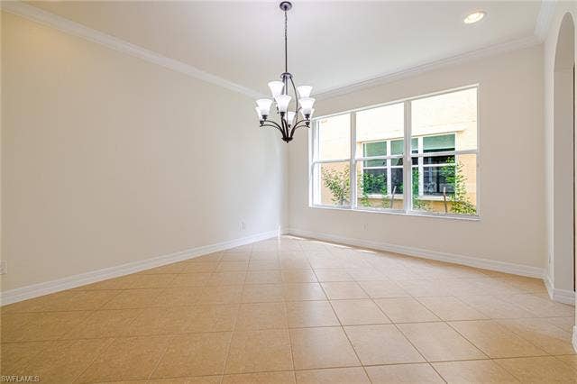 10310 Carolina Willow Dr, Fort Myers, FL 33913 Tile flooring, crown molding, modern chandelier, recessed lighting, arched entryway