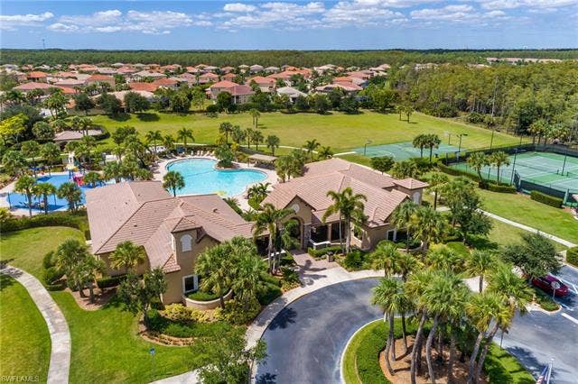 10310 Carolina Willow Dr, Fort Myers, FL 33913 Community amenities featuring multiple swimming pools, sports courts, expansive green spaces, and mature landscaping