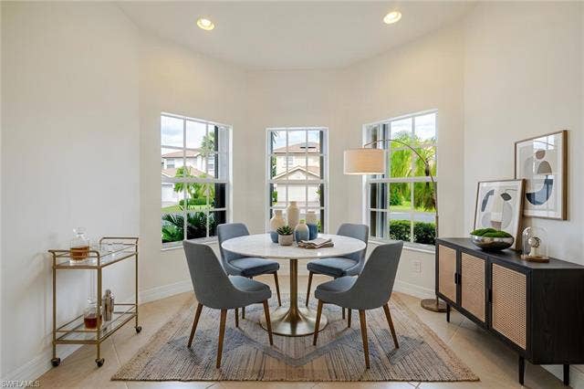 10310 Carolina Willow Dr, Fort Myers, FL 33913 Vaulted ceiling with recessed lighting, tile flooring, and multiple large windows