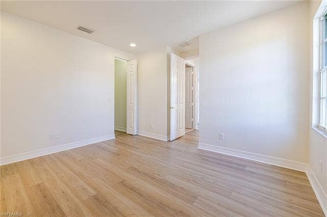 10310 Carolina Willow Dr, Fort Myers, FL 33913 Light wood-finish flooring, white walls, recessed ceiling lighting, and a white window frame