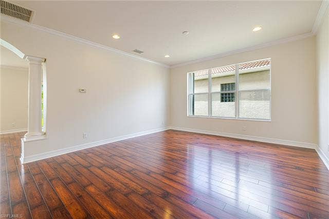 10310 Carolina Willow Dr, Fort Myers, FL 33913 Spacious room featuring wood-finish flooring, white baseboards, crown molding, recessed lighting, and a large window