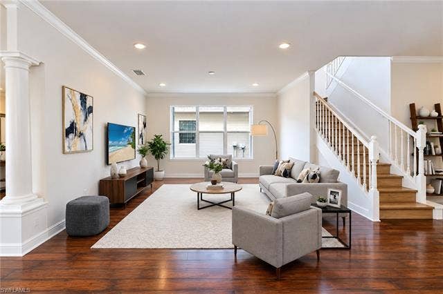10310 Carolina Willow Dr, Fort Myers, FL 33913 Hardwood flooring, recessed lighting, crown molding, white painted trim, and a white baluster staircase