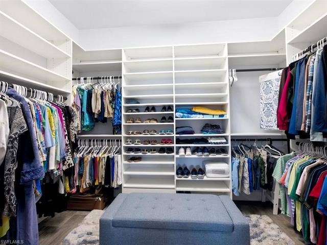 19125 Aqua Shore Dr, Estero, FL 33913 Primary custom closet with extensive shelving, multiple hanging rods