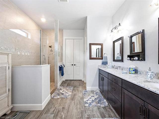 19125 Aqua Shore Dr, Estero, FL 33913 Primary bath with dual vanity and walk-in shower